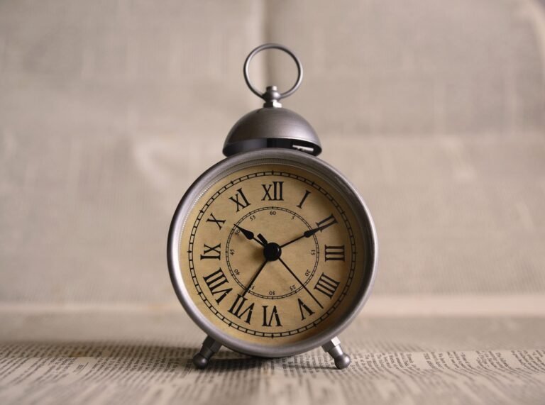 Classic alarm clock with roman numerals on a bedside table