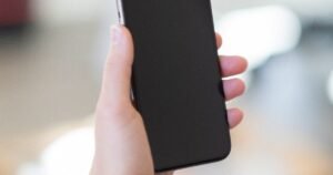 Hand holding a smartphone during an Android privacy settings checkup