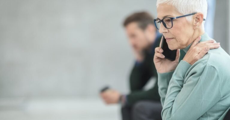 Woman using a phone, illustrating how Android spam call warnings help with unknown calls