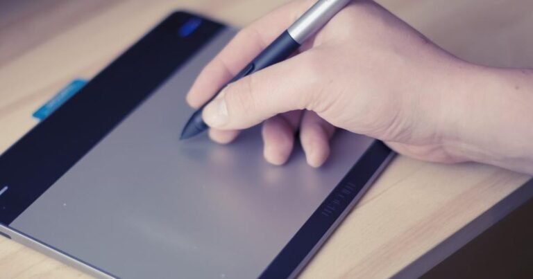 Hand using a stylus on a compact tablet, representing small Android tablet choices
