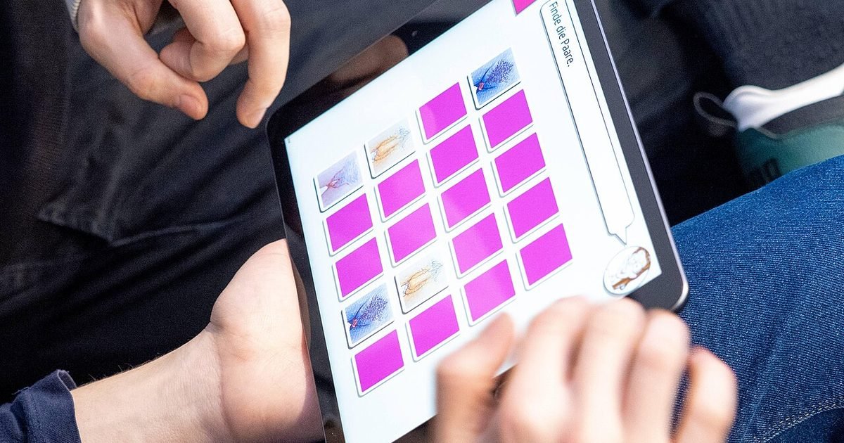 People playing a touch game on a small tablet, representing compact tablet gaming