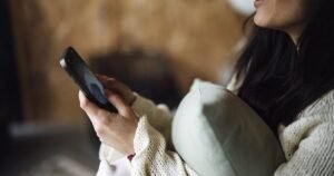Person holding an Android phone while troubleshooting home screen widgets