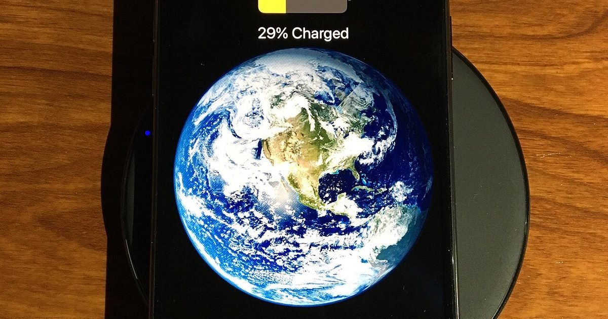 Smartphone charging on a wireless charger during a battery and heat check